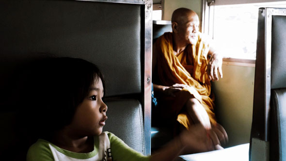 Girl and Monk on Train | Ronn Aldaman