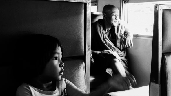 Girl and Monk on Train | Ronn Aldaman