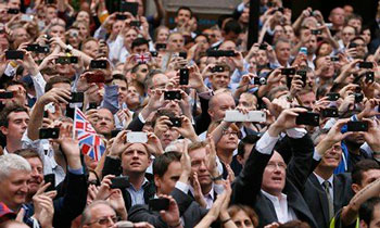 Spectators taking pictures of the British team's celebration parade after the London 2012 Olympics. | AFP / Getty Images