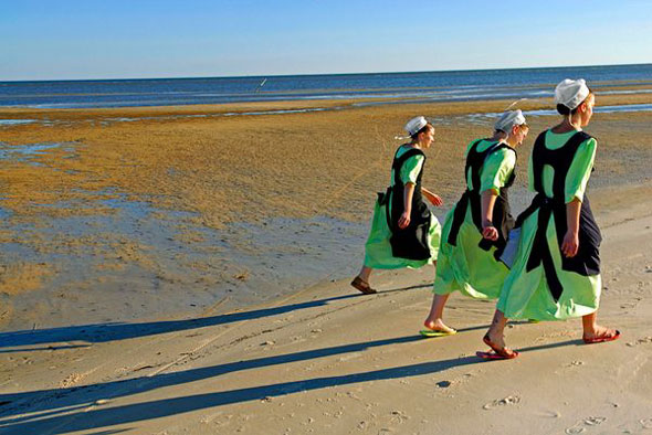 Amish Women on Beach -- Amish women walk on a beach in Waveland, Mississippi. | Johnny Nicoloro / National Geographic