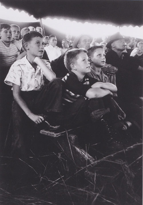Cover the top of this image with your hand. Look at it for 10-15 seconds.  Get used to the tones of the children’s faces.  Now remove your hand.  See how the glowing light jumps out at you.  Its too strong of a value shift in a part of the picture that has no importance. Indiana, 1949. | Robert Capa