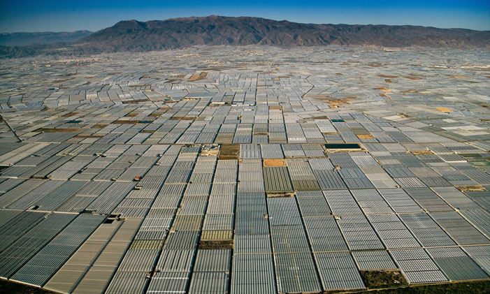 Greenhouses Grow Greenhouses As far as the eye can see, greenhouses cover the landscape in Almeria, Spain "We are slaves in the sense that we depend for our daily survival upon an expand-or-expire agro-industrial empire – a crackpot machine – that the specialists cannot comprehend and the managers cannot manage. Which is, furthermore, devouring world resources at an exponential rate." (Edward Abbey) | Yann Arthus Bertrand / Population Speak Out